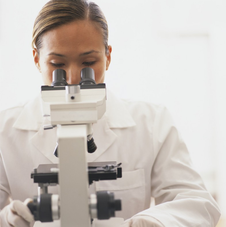 Female Scientist Looking through Microscope