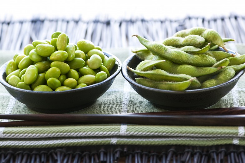 Edamame soy beans shelled and with pods in bowls